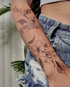 a woman with a flower tattoo on her arm