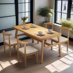 a wooden table with four chairs around it in front of large windows and potted plants