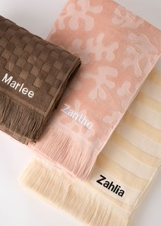 three towels with the names marlie and zahla on them