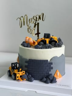 a birthday cake decorated with construction vehicles