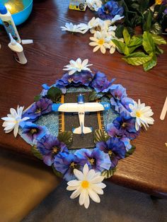 a wreath with flowers and an airplane on it