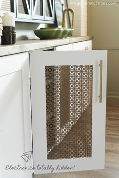 a white cabinet with a laser cut design on the front and side door, in a kitchen