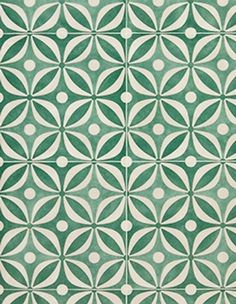 a green and white rug with circles on the floor in an intricate pattern, designed by hand