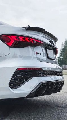 the rear end of a white sports car