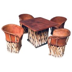 four chairs and a table made out of woven material with leather seats on each side