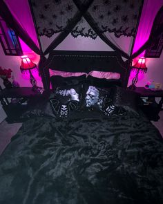 a bed with two pillows on top of it in front of a purple light that is turned on