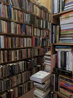 a bookshelf filled with lots of books on top of each other in a library