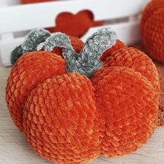 an orange stuffed pumpkin sitting on top of a table