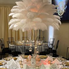 the centerpieces are decorated with white feathers