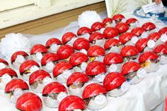 many red hard hats are on display for sale