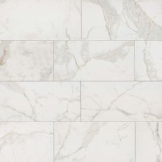 a white marble tile wall that looks like it has been polished