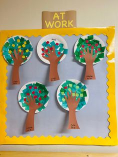 four paper plates with trees on them and the words at work written in different languages