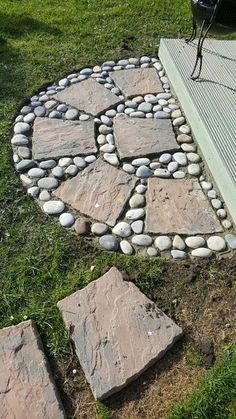 some rocks are arranged in the shape of a circle on top of a wooden deck