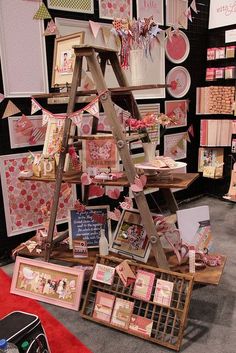 a display in a store filled with lots of cards and paper crafts on wooden shelves