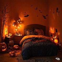 a bedroom decorated for halloween with pumpkins and bats