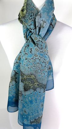 "Delivery by Christmas not guaranteed, although items are sent out very quickly. Upgrade to Priority Mail at checkout to have a better chance of pre-Christmas delivery! Fractal beauty on silk chiffon in subtle shades of light blue and gold! This lovely, long shawl/scarf recalls the complexity of Islamic art, but the pattern is actually a multi-layered fractal design. Length is 78 inches, long enough to knot and wrap almost any way you wish. The silk chiffon used for this scarf is a very tight we Blue Shawl Scarf For Gift, Elegant Blue Shawl Scarves, Elegant Blue Silk Shawl Scarf, Elegant Blue Silk Shawl, Meditation Shawl, Blue Silk Scarf, Long Silk Scarf, Shades Of Light Blue, Gold Wrap