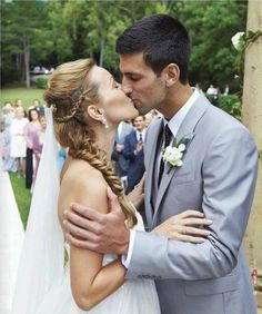 a bride and groom kissing in front of an outdoor ceremony