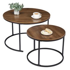 two wooden tables with black metal legs and a cup of coffee on the table top