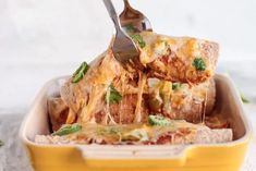 a yellow dish with lasagna casserole being lifted from the casserole