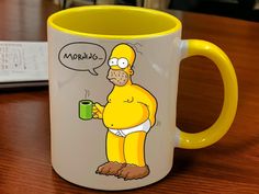 a yellow mug with a cartoon character holding a cup