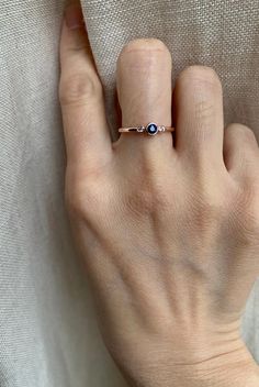 Genuine sapphire-adorned three stone ring. 14k Rose gold fully hallmarked 3mm blue Sapphire center stone. 1.75mm White Sapphires Approx 1.5mm band width FREE SHIPPING USA- All of our jewelry will arrive in custom packaging ready for gift giving. LEAD TIME: Made to order will take 10-14 days. Signature upon delivery, we unfortunately will not be able to reimburse or replace lost or stolen shipments. FOLLOW US ON: Instagram: @roseandchoc Facebook: /Roseandchoc Pinterest: @Roseandchoc Blue Sapphire Three-stone Birthstone Ring, 14k Gold Blue Three Stone Jewelry, Rose Gold Sapphire Promise Ring With Birthstone, Rose Gold Round Cut Sapphire Ring, Rose Gold Sapphire Ring With Round Cut, Sapphire Three Stone Diamond Ring Gift, 14k Rose Gold Sapphire Promise Ring, Sapphire Three Stone Ring In 14k Gold, Blue Three Stone Birthstone Ring As A Gift