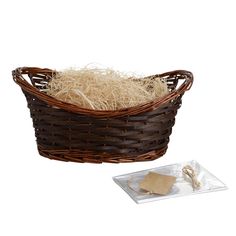 a basket with hay in it next to a tag