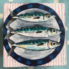 three fish on a plate with polka dots