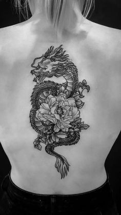 a woman with a dragon tattoo on her back