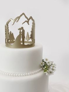 a wedding cake with a bride and groom on top