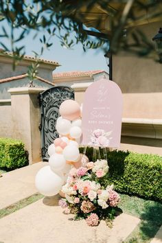 a table with balloons and flowers on it