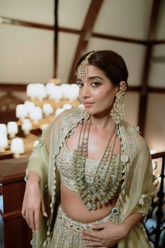 a woman in a bridal outfit posing for the camera