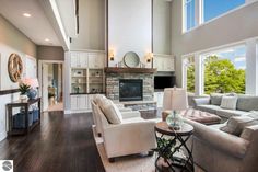 a living room filled with furniture and a fire place in the middle of a room