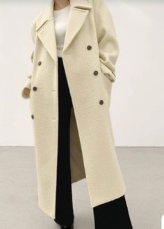 Richly textured alpaca wool coat in a structured oversized silhouette. Handmade. - Oversize cut- Notched lapel- removable neck storm front- Padded shoulders- Double breasted- 3 button closure- Contrast buttons- Front flap pockets- Adjustable back waistcoat cinch- Back vent- Measurements: Length 44.5", Bust 50", Sleeve 30"- Outer: Wool 70%, Alpaca 10%, Nylon 20% Lining 100% Polyester - Dry clean- Imported Cream Double-breasted Long Coat, Oversized Single-breasted Wool Coat With Notch Lapel, Wool Coat With Double-breasted Button Fastening, Tailored Beige Single-breasted Wool Coat, Luxury Beige Double-breasted Wool Coat, Alpaca Coat, Storm Front, Oversized Silhouette, Alpaca Wool