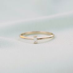 14k Gold Diamond Baguette Ring, Dainty Stacking Ring, Engagement Ring Features : -Gold KT: 14K Solid Gold -Custom Gold Color: Yellow Gold -Diamond Cut: Baguette -Total CTW: 0.06 ctw -Diamond Color Clarity: G Color SI Clarity -Setting Type: Prong -Ready to Ship in 1-2 Business Days -Packed in labeled gift box -The perfect birthday or holiday (Christmas, hanukah, valentines day...etc.) gift! -FREE shipping on all U.S. orders Contact us with any inquiries by Etsy convo or by email: rebecca@letreaim Diamond Baguette Ring, Dainty Wedding Band, Birthstone Stacking Rings, Logo Jewelry, Diamond Baguette, Engagement Ring Prices, Baguette Diamond Rings, Baguette Ring, Bracelets Gold Diamond