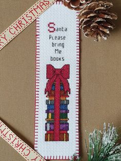 cross stitch bookmark with ribbon and pine cone