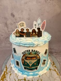 there is a cake that has been decorated with people and surfboards on top of it