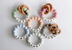 several different types of beads are arranged on a white surface with words spelled in them