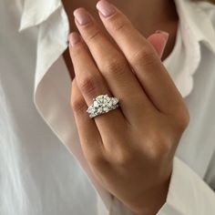 a woman's hand with a diamond ring on it