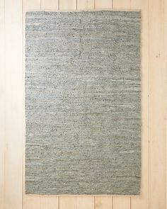 a gray rug on a wooden floor