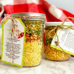 two jars filled with food sitting on top of a table