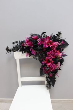 a bouquet of flowers sitting on top of a white chair