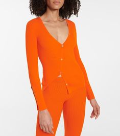 Jacquemus' designs never fail to put us in a sunny state of mind, and the zesty orange shade of the Tordu cardigan is particularly uplifting. Part of a vibrant capsule designed exclusively for Mytheresa, it captures the brand's alluring style with a ribbed finish that follows the body's contours. Note the asymmetric, midriff-baring hem: A label-signature detail that we love. Orange Fitted Long Sleeve Cardigan, Fitted Long Sleeve Orange Cardigan, Fitted Orange Long Sleeve Cardigan, Orange V-neck Cardigan For Spring, Fitted Orange Cardigan For Spring, Stirrup Leggings, Designer Shopping, Body Contouring, Shades Of Orange