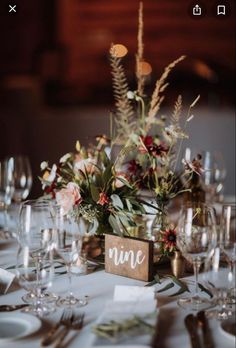 the table is set with wine glasses and place cards for guests to sit down at