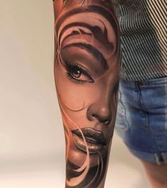 a woman's leg with tattoos on it and her face painted to look like a woman