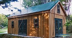 a small wooden building sitting in the middle of a forest