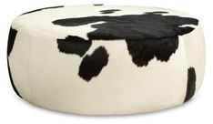 a black and white cow print ottoman