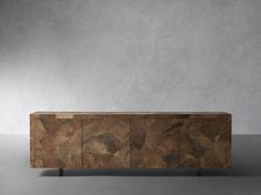 a large wooden cabinet sitting on top of a cement floor next to a white wall