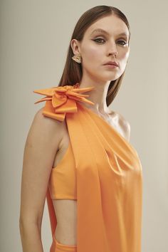 Elegant One-Shoulder Orange Crepe Satin Dress Turn heads with our elegant one-shoulder orange crepe satin dress, designed to make you the center of attention at any event. Combining luxurious fabric with a bold color, this dress is perfect for glamorous occasions. Features: Luxurious Fabric: Made from 100% polyester crepe satin, this dress offers a smooth, silky finish that drapes beautifully. Striking Color: The vibrant orange hue adds a touch of boldness and energy, ensuring you stand out in a Center Of Attention, Jumpsuit Jacket, Sweatshirt Set, Scarf Headband, Bold Color, Vibrant Orange, Satin Dress, Dress With Cardigan, Luxury Fabrics