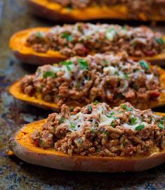 stuffed sweet potatoes with ground meat and cheese on the top are ready to be eaten