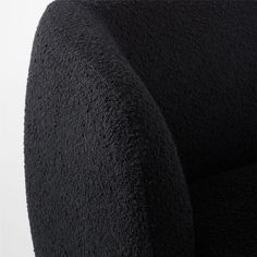 an upholstered black chair is shown with the back and arms folded in two different directions